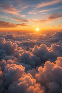 the sun is setting over some clouds