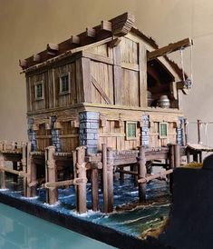 a model of a wooden house on water
