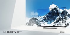 the lg oleed tv is on display in front of a snowy mountain backdrop