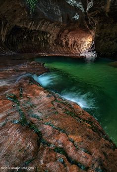 the inside of a cave with water running through it