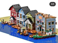 there is a lego model of some houses on the water
