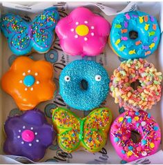 a box filled with lots of colorful donuts