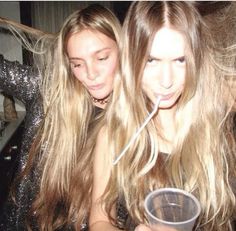 two beautiful young women standing next to each other