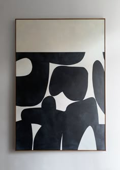a black and white painting hanging on the wall