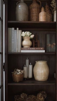 a book shelf filled with books and vases