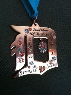 a medal with the words strength and soul on it, hanging from a blue ribbon