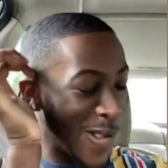 a man is talking on his cell phone in the car