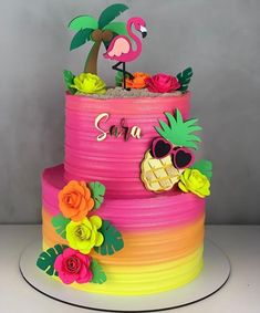 a colorful cake decorated with flowers and a flamingo on top