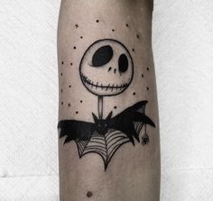 a tattoo on the leg of a person with a skull and spider web around it