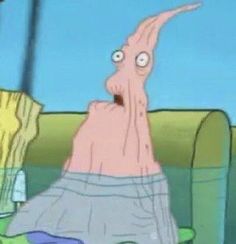 an octopus is sitting on a couch with his head in the air and eyes wide open