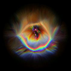 an image of a colorful object in the dark with light coming from it's center