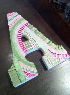 the letter e is made out of paper and cut into smaller pieces to make it look like a train track