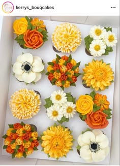 cupcakes decorated with flowers are in a box
