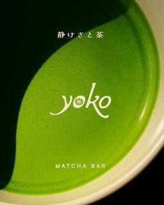 the yoke matcha bar logo is displayed on a green plate with white lettering