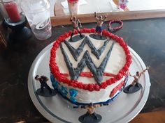 a birthday cake decorated with wrestling figures