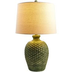 a green table lamp with a beige shade