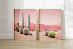 two framed images of cactus in the desert with pink sky and mountains behind them, on a wooden floor