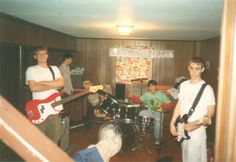 a group of young men playing instruments in a room