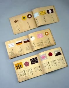 an open book with japanese writing on it and two smaller books next to each other