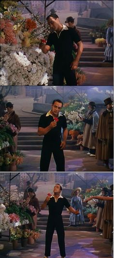 there is a man standing in front of flowers