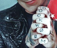 a man with tattoos on his hands and the words rock'n'roll written in small letters