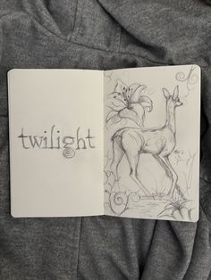an open book with a drawing of a deer and the word twilight on it's cover