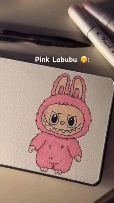a mouse pad with a drawing of a pink rabbit on it's face and the words pink labbu