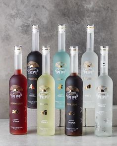 several bottles of different types of alcohol sitting on a counter top next to each other