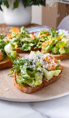several pieces of bread topped with lettuce and cheese