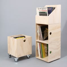 a wooden shelf with magazines on wheels next to it