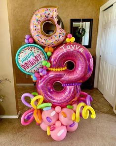 a giant balloon sculpture made to look like a number five with balloons and donuts