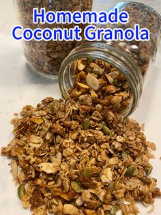homemade coconut granola in a glass jar on a white counter top with the words homemade coconut