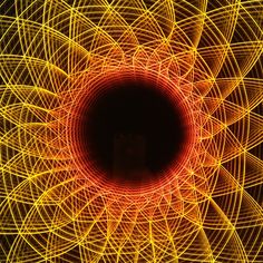 an abstract photo with yellow and red lights in the center, looking like a flower