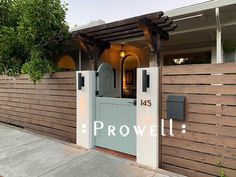 the front entrance to a house with a wooden fence and gate that says prowell