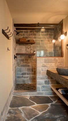 a bathroom with stone walls and flooring