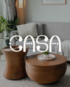 Casa logo in front of show lounge with sofa, tables, cushions and throws.