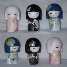 four small dolls with different designs on them