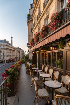 tables and chairs are lined up on the sidewalk outside an apartment building in paris, france