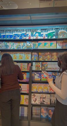 two women looking at comic books in a store