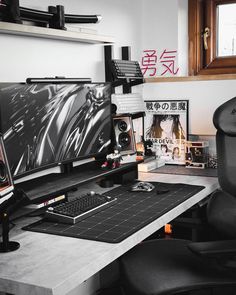 a computer desk topped with a monitor and keyboard