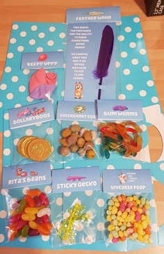 a table topped with lots of candy and candies next to a blue sign that says sticker gummy