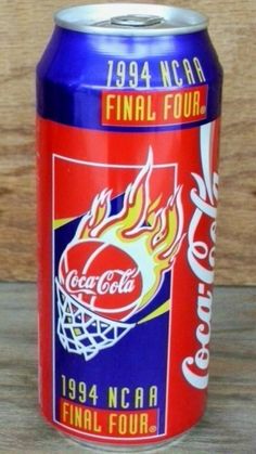 a can of coca cola on a wooden table