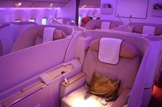 the inside of an airplane with purple lighting