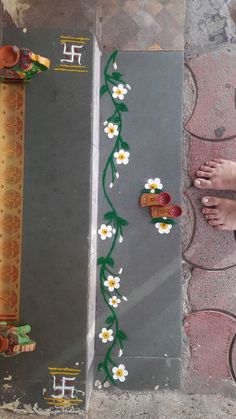 two people standing next to each other with flowers painted on the side of their feet