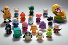 a group of toy figurines sitting on top of a white table next to each other