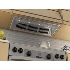 a stove top oven sitting inside of a kitchen next to a wall mounted exhaust fan