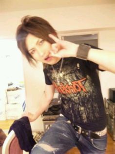 a young man sitting on top of a wooden floor