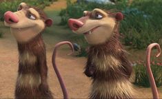 two animated monkeys standing next to each other on a dirt road with grass and flowers in the background