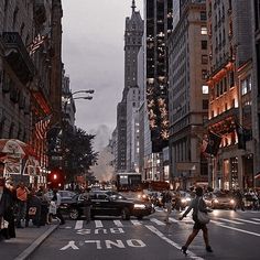 people crossing the street at night in new york city