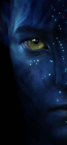 a man with yellow eyes and blue skin has glowing stars on his face as he stares at the camera